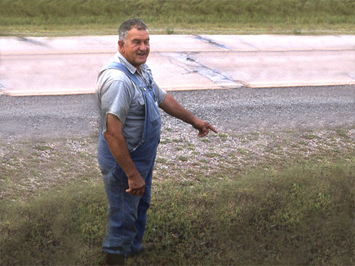 Stanley Moucka points out where he found Baba, Mehera, and Mehru lying injured in the ditch by the roadside.