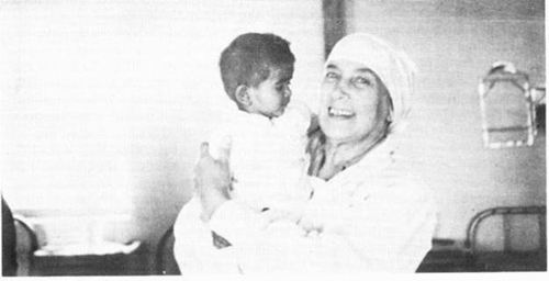 Nadine with young child in Meherabad clinic-1937
