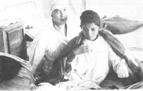 Nadine with young boy in clinic-Meherabad, 1937